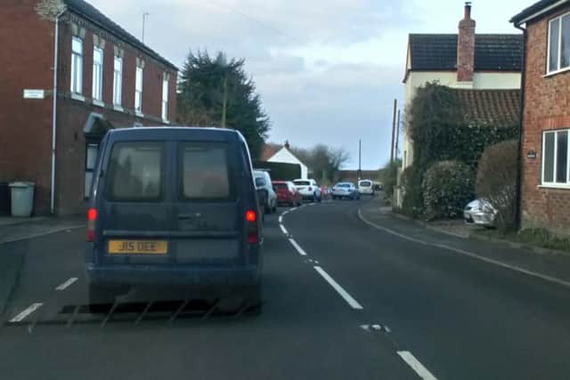 The waiting game: Queuing traffic at a set of temporary lights on the A153 in West Ashby.