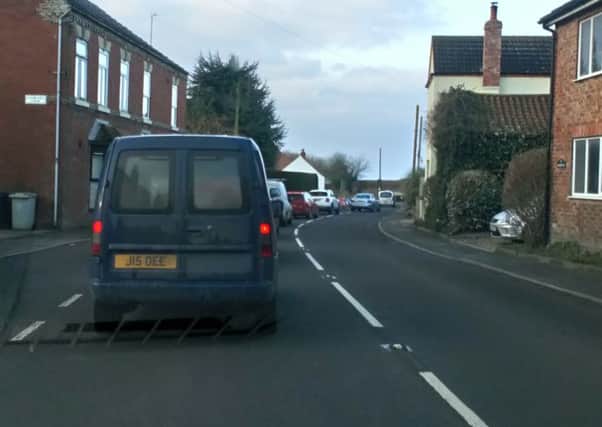 The waiting game: Queuing traffic at a set of temporary lights on the A153 in West Ashby.