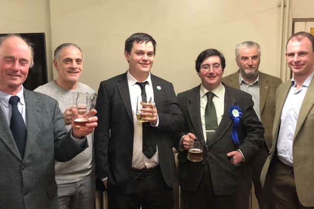 Tom Ashton (centre right) serves a well earned pint to the campaign team after the Wrangle election. From left, Coun Jonathan Noble, Coun Nigel Welton, Coun Martin Griggs, Coun Tom Ashton, Coun Michael Cooper and Matt Warman MP. Photo supplied. EMN-180223-141423001