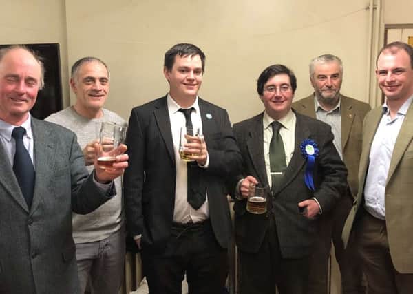 Tom Ashton (centre right) serves a well earned pint to the campaign team after the Wrangle election. From left, Coun Jonathan Noble, Coun Nigel Welton, Coun Martin Griggs, Coun Tom Ashton, Coun Michael Cooper and Matt Warman MP. Photo supplied. EMN-180223-141423001