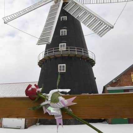Floral tribute left on the gate of Heckington Windmill, after the death of volunteer Pete Lett in an accident.