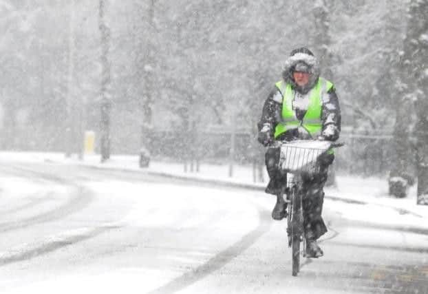A cyclist in the heavy snow