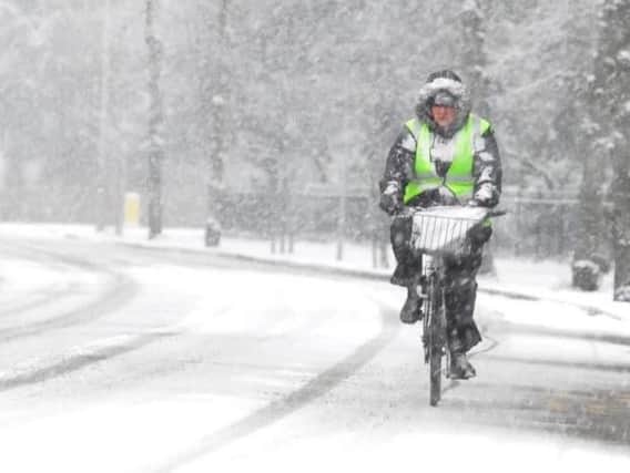 A cyclist in the heavy snow