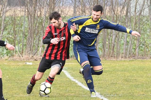 Park United's Dan Huskisson (right) in action at the club's current Tattershall Road home.