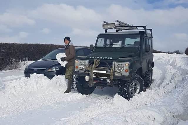 Keith Mallinson clearing the way for another car to escape the snowdrifts EMN-180503-154227001
