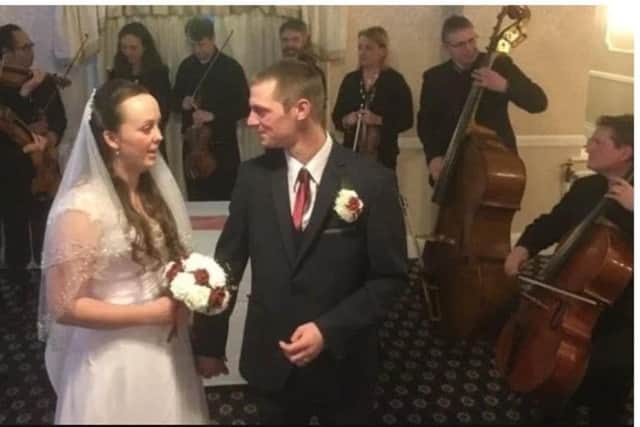 Lisa and Reece Brown at their wedding at the Crown Hotel in Skegness, with the BBC Orchestra playing for them in the background. ANL-180603-083808001
