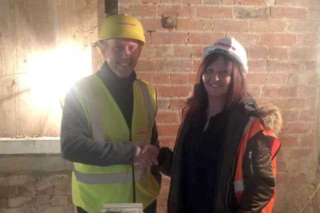 Market Rasen station's first tenant Mandy Wilton shakes hands with architect Ian Hind from Lindum. EMN-181203-175907001