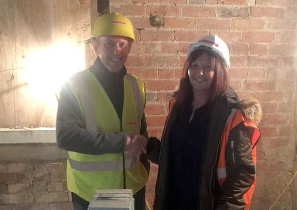 Market Rasen station's first tenant Mandy Wilton shakes hands with  architect Ian Hind from Lindum. EMN-181203-175907001