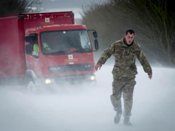 RAF Wittering personnel helping out motorists in the snow in Lincolnshire last week