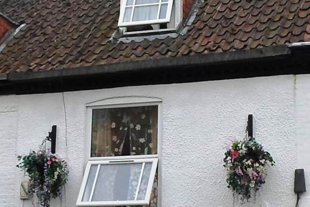 A picture presented to magistrates showing the unauthorised upper-floor UPVC window replacements in the Grade II listed building. Photo supplied. EMN-180803-111722001