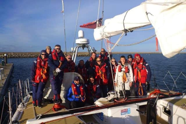 Andy Burns (centre) with his crew on board the GREAT Britain entre in the Clipper Round the World race. ANL-180803-131534001