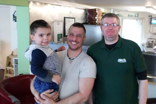 The happiest man alive: Paul Edwards (centre) with son Elliott (5) and  owner Graeme Midgley at Unos Pizzeria and Bistro in Horncastle.