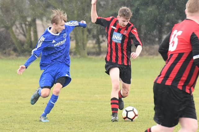 Woodhall Spa Reserves (red) v Swineshead Institute A (blue). Ollie Cranfield (red), Cam Atkinson (blue).