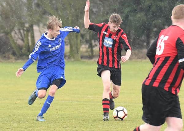 Woodhall Spa Reserves (red) v Swineshead Institute A (blue). Ollie Cranfield (red), Cam Atkinson (blue).