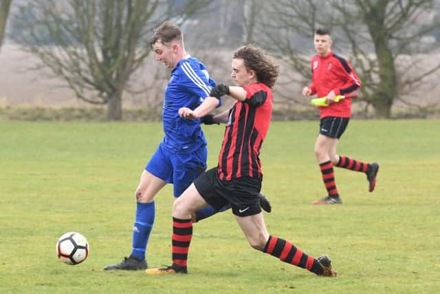 Woodhall Spa Reserves (red) v Swineshead Institute A (blue). Jordon Barrand (red), Luke Hackett (blue).