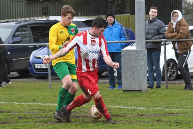 Horncastle (red) v Skegness (yellow). Scott Lowman (red), Ryan O'Loughlan (yellow).