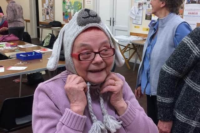 Pictured is Ruth Cook trying on a Fairtrade bunny hat.