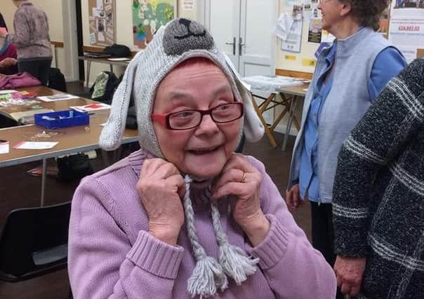 Pictured is Ruth Cook trying on a Fairtrade bunny hat.