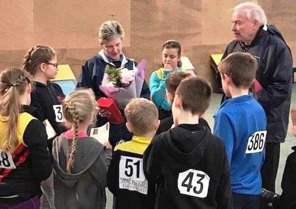 Sportshall youngsters present Nanette Johnson with flowers to celebrate her 65th birthday. Nanette has been coaching at Boston and District AC for 19 years.