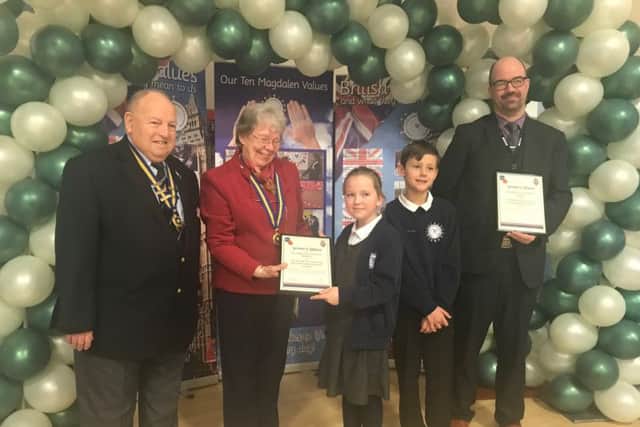 Tony Goodwin, charman of Lincolnshire Royal British Legion, with local chairman Pat Nicholsas presenting the certificate of affiliation to Lucy Robinson, 9, Daniel Wilkinson, 9, and headteacher Gareth Smith. ANL-180316-171605001