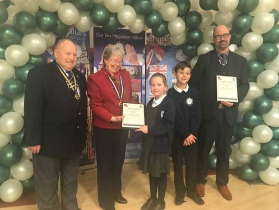 Tony Goodwin, charman of Lincolnshire Royal British Legion, with local chairman Pat Nicholsas presenting the certificate of affiliation to Lucy Robinson, 9, Daniel Wilkinson, 9, and headteacher Gareth Smith. ANL-180316-171605001