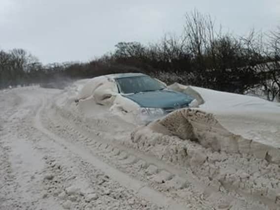 A car stuck on Boston Road in Wainfleet off the A52. Photo: Betty Cole ANL-180103-154418001