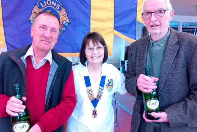 Outright winners Roy Hughes and Andy Milner with Lion president Pat Phillips EMN-180318-141108001