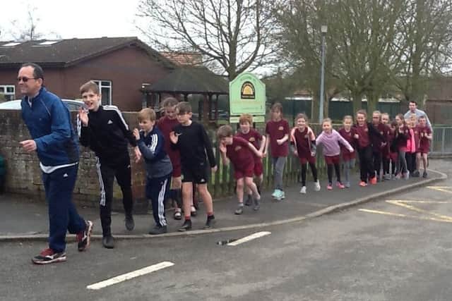Kelsey Primary School interim headteacher Matt Ashmead takes his pupils for a lunchtime run in the village EMN-180319-110854001