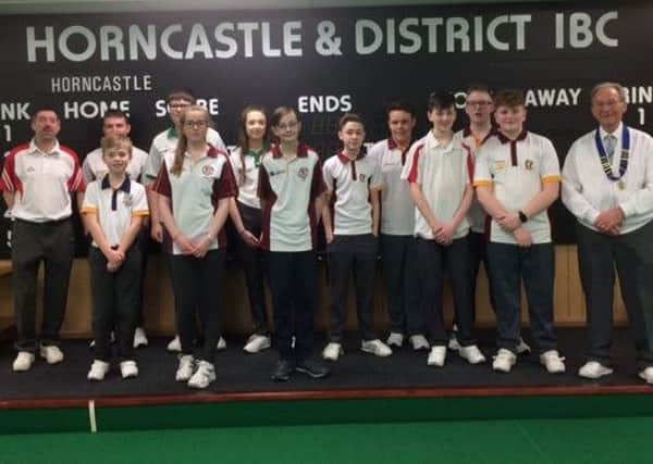 The 12 under 18 bowlers who competed on Sunday are pictured with Rod West and far right George Wells HIBC president.