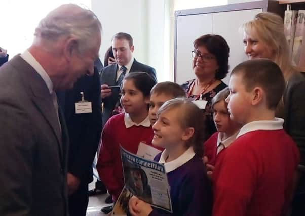 His Royal Highness Prince Charles with pupils from Boston's Carlton Road Academy at Age UK Boston and South Holland's office in the town.