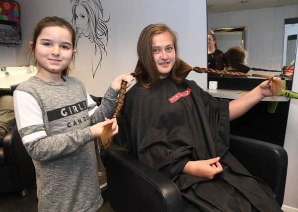 Sarah Simms getting her hair cut off at Cutting Cupboard, Coningsby, to be donated to Little Princess Trust in support of Amira Bell who has been diagnosed with alopecia. Sarah Simms with Amira Bell 8. EMN-181203-113931001