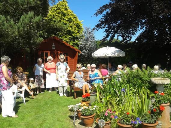 Happy memories: The 2016 WI garden party, hosted by Anne. ANL-180320-114328001