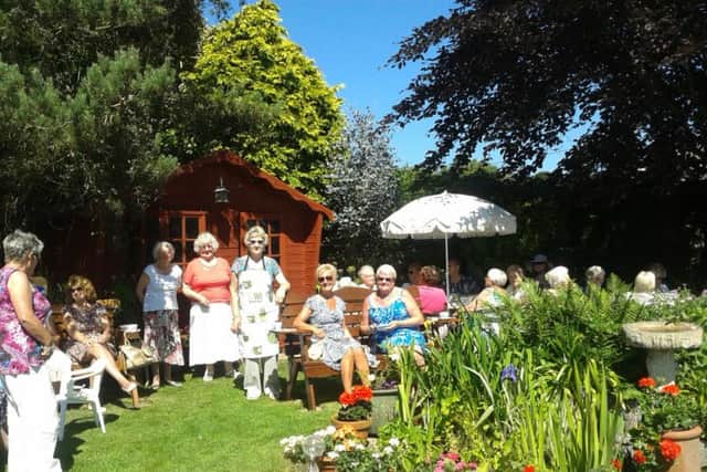 Happy memories: The 2016 WI garden party, hosted by Anne. ANL-180320-114328001