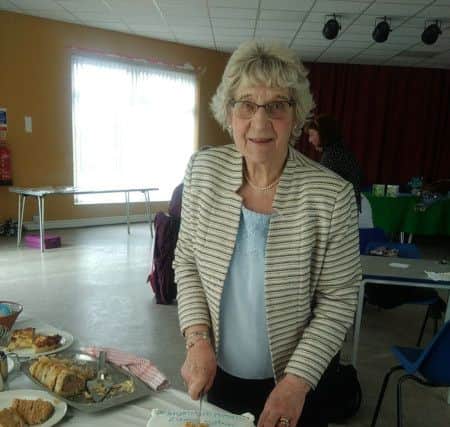 Anne Laxton cutting her cake at her retirement presentation. ANL-180320-114519001