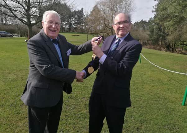 Outgoing Probus president Bryan Storey, left, hands the chain of office onto incoming president Ian Johnson. EMN-180320-170542001