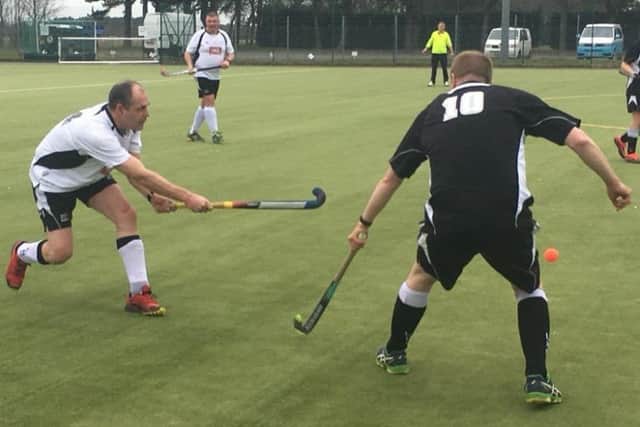 Third team captain Andy Cade (white) competes to clear his lines under pressure from Leadenhams leading scorer James Ireland EMN-180326-143317002