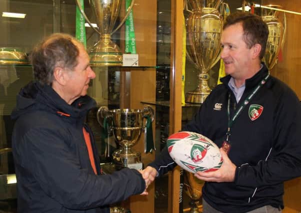 Arthur receives a signed rugby bally from Leicester Tigers head of Community, Scott Clarke EMN-180321-170939002