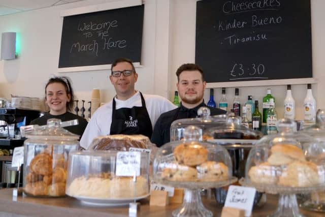 Trevor Guerin (centre) with staff members Sophie Clarke and James Cordell EMN-180326-100725001