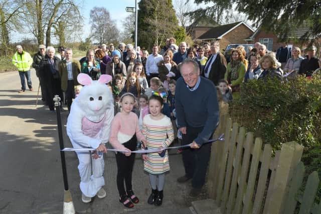 Evie Locking (9) and Eleanor Dale (8) help cut the ribbon to unveil the new footpath.