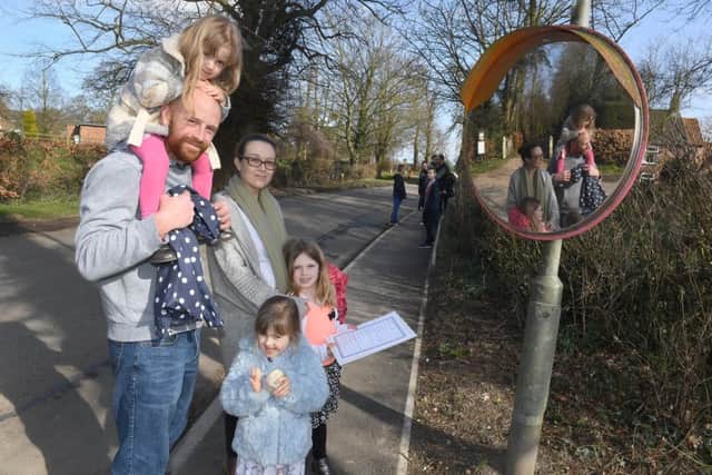 Ian and Helen Carter with their children Scarlett (3), Eva (3) and Phoebe (6) taking part in the treasure hunt along the footpath.