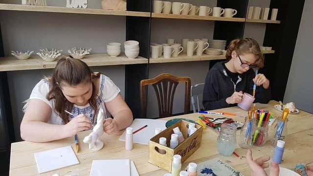 Painting pottery at 'Crackpot' in Louth.