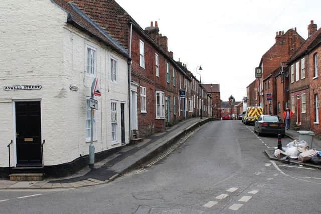 The motorbikes and cars approach from Aswell Street (right) and then turn right down Kidgate, towards Upgate.