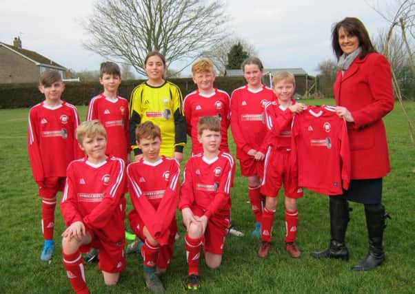 Kirkby La Thorpe Church of England Primary Academy football team being presented with their new kit by Liz Penson of Wheelcraft.