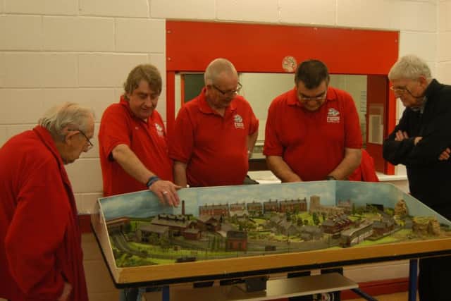 Club members busy testing out on of their completed layouts. EMN-180330-155305001