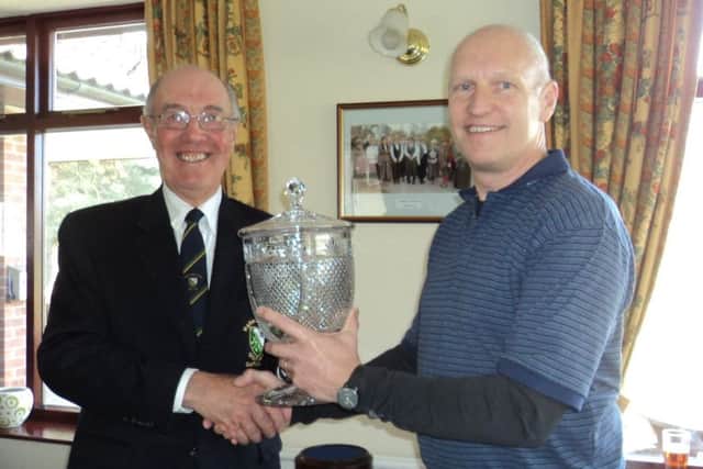 Market Rasen GC club captain Ian Ribey (left) presents the Match Trophy to his vice-captain Robert Pearce EMN-180328-173234002