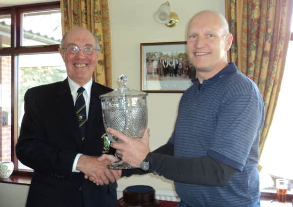 Market Rasen GC club captain Ian Ribey (left) presents the Match Trophy to his vice-captain Robert Pearce EMN-180328-173234002