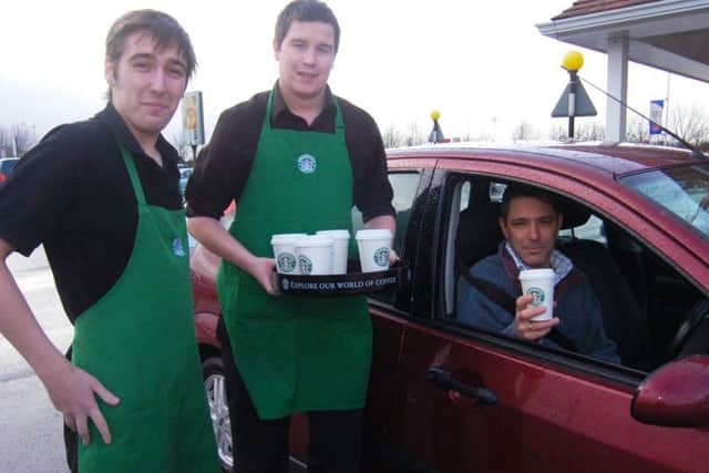 Cheers... pictured (from left) trainee supervisor Luke Ayre and manager Craig Wilkinson, of Starbucks, with stranded motorist Mark Vazro, of Pinchbeck.