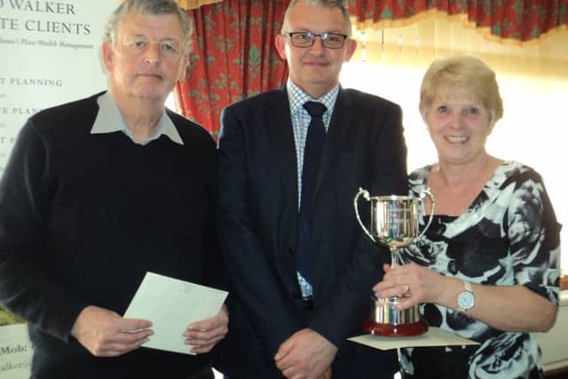 Richard Walker (centre) of RJW Private Clients (Wealth Management) presents the Walker Cup to winners John Wilson and Tilly Lawrence EMN-180328-173222002