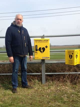 Councillor Robert Webb, Chairman BGPC, with the specialist debibrillator at Bardney Lock EMN-180804-184021001