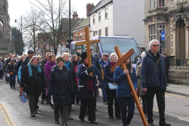 The Sleaford churches Walk of Witness procession snakes its way past the handley Monument.